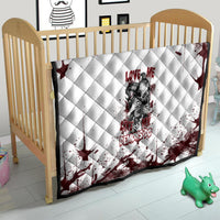 Skull quilt on a child bed frame, white quilted fabric with dark red splatter design