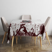 Skull tablecloth with maroon splatter and dark skull graphic, laid across round table