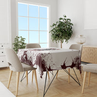 Skull tablecloth with maroon ink splatter pattern, set on dining table with chairs