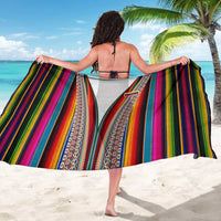 Multicolor vertical stripe woven sarong worn as a beach wrap
