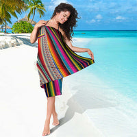 Multicolor striped woven sarong with geometric border, draped over one shoulder