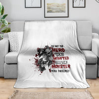 White blanket with black hero-and-monster portrait graphic and red stacked slogan text