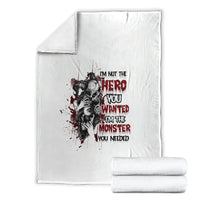 White blanket with hero-and-monster graphic and red stacked slogan text, folded neatly