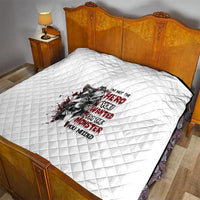 White quilt with diamond texture, red and black “hero/monster” text graphic on bed