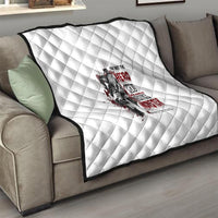 White diamond-quilted throw blanket with red and black hero/monster graphic on sofa