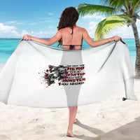 White graphic sarong with dark text and monster illustration, tied at the waist.