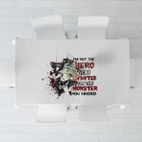 White tablecloth with centered red and black quote graphic, laid flat from above