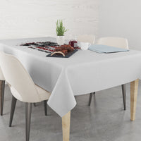 Light gray tablecloth with black-and-red quote graphic on a dining table with cups