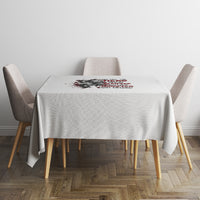 Light gray tablecloth with red-and-black quote graphic, covering a dining table and chairs