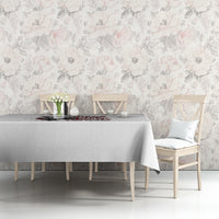 Light gray tablecloth with red-and-black quote graphic on a dining table against floral wall