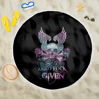 Round black beach blanket with skull, winged motif, purple roses, fringe trim.
