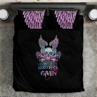Black bedding set with central winged skull graphic and purple scaly-feather pillowcases