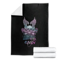 Black skull, wings, and roses throw blanket with folded white stacks