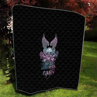 Black quilt with rounded corners, diamond quilting, and multicolor skull wings and roses.