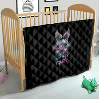 Black quilt on toddler bed with diamond quilting and multicolor skull-wing rose graphic.
