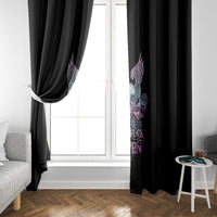 Black curtain with winged skull and roses print along one side near the window