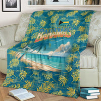 Tropical beach blanket on beige armchair with Bahamas logo, palm leaves, and sea