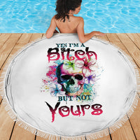 Round white beach blanket with colorful skull print and fringed edge, on model