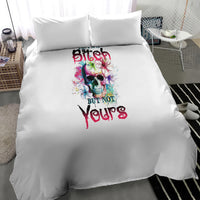 White duvet bedding set with centered multicolor skull and 'yours' lettering, two pillows