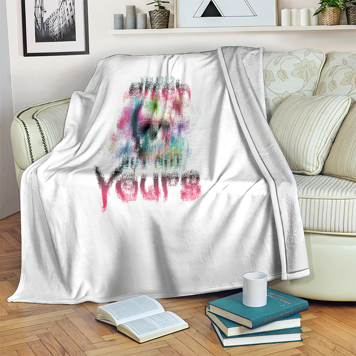 White blanket draped over sofa with colorful skull graphic and slogan