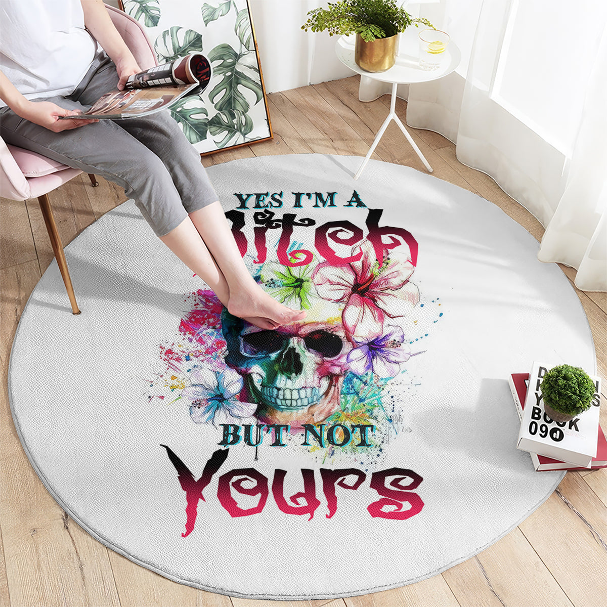 Round white carpet with multicolor skull graphic and graffiti-style text print.