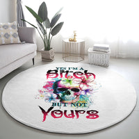 Round white carpet with multicolor skull, flower accents, and layered text print.