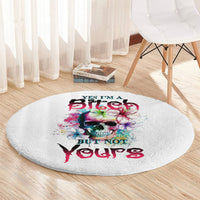 Round white carpet with multicolor skull and floral splatter graphic, centered text.