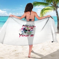 White multicolor skull and text graphic sarong, draped and held wide