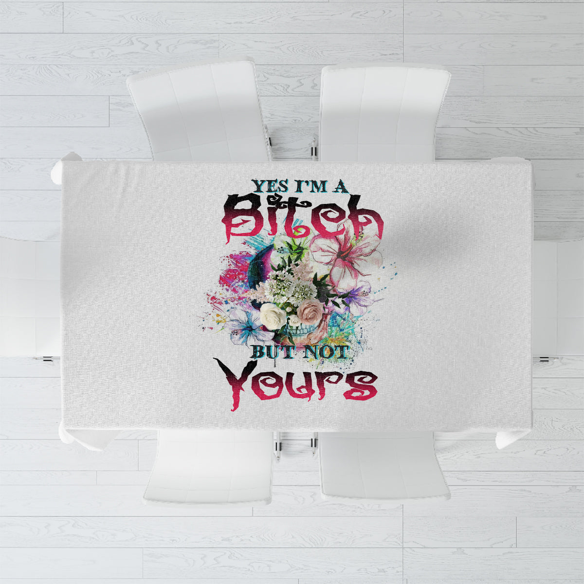 Light gray multicolor printed tablecloth with centered floral and text graphic, top view