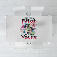 Light gray multicolor printed tablecloth with centered floral and text graphic, top view
