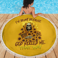 Round yellow beach blanket with skull-and-sunflower design and fringed white border