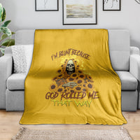 Sunflower reaper throw blanket, golden yellow, skull and flower graphic on couch