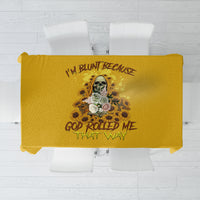 Yellow tablecloth featuring a skull reaper illustration with floral details