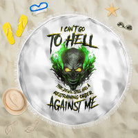 Round white beach blanket with green skull graphic and fringe trim