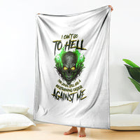 White skull graphic blanket draped upright, green fire-eyed skull with text