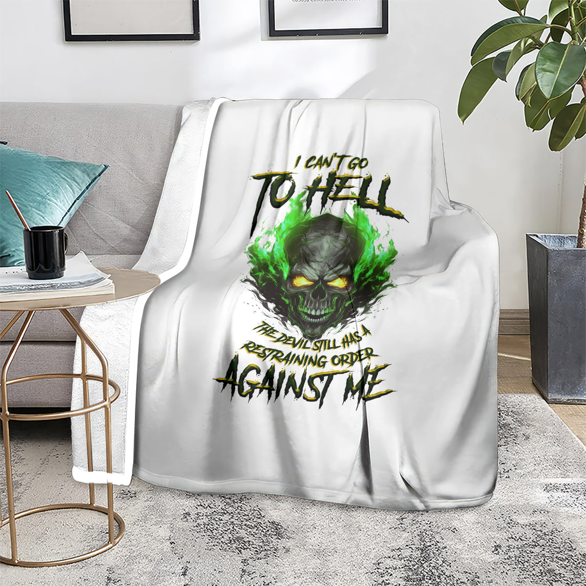 White skull graphic blanket over armchair, green fire-eyed skull design