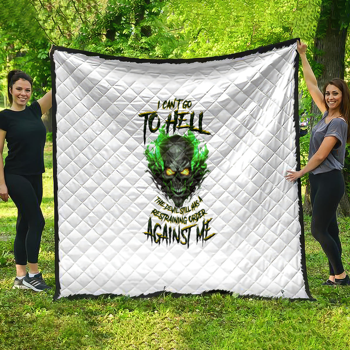White quilted blanket with green skull graphic and bold dark lettering