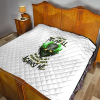 White quilted bedspread with green skull artwork and dark typographic text