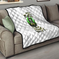 White quilted blanket on sofa, green skull graphic centered with black text