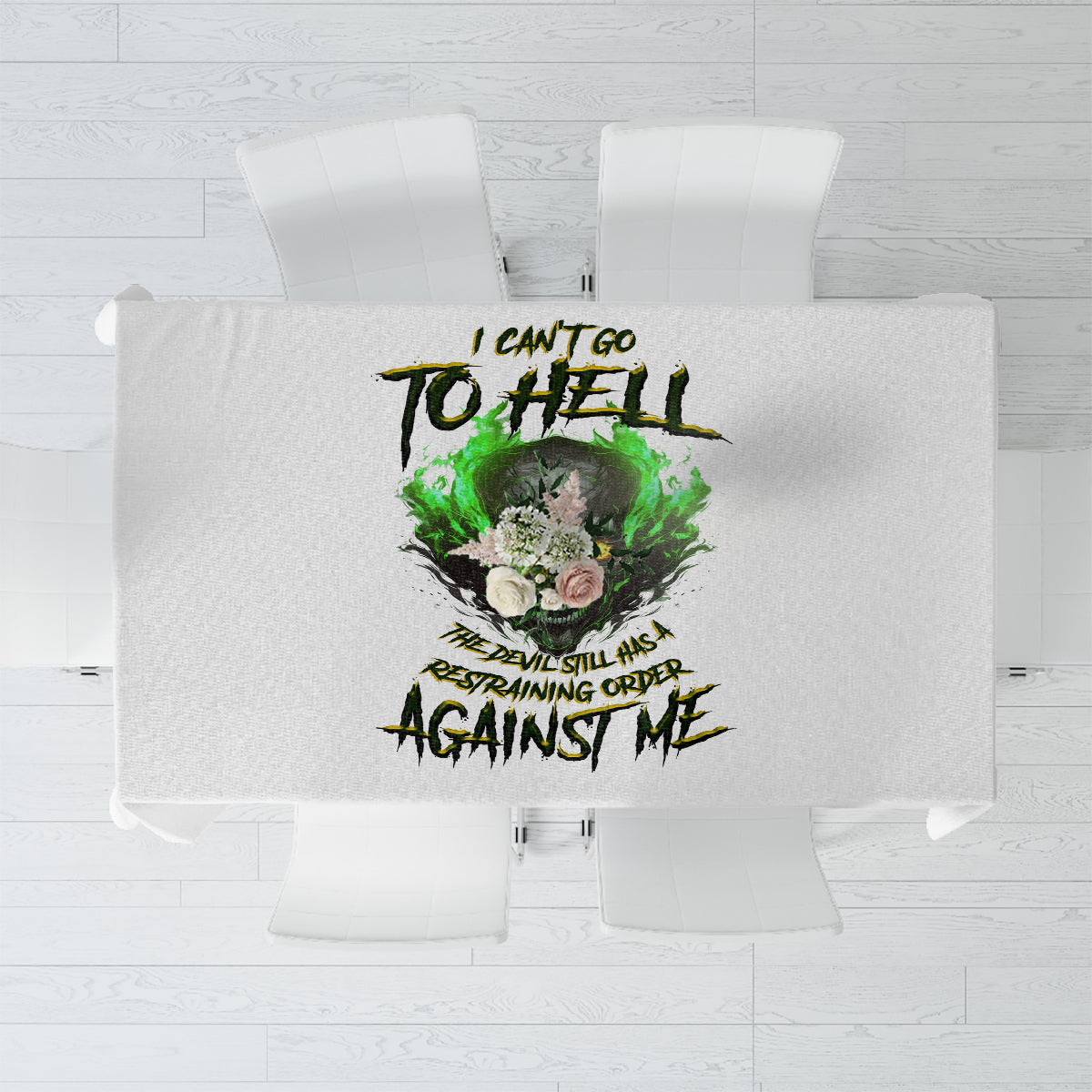 Printed tablecloth showing green skull and devil-themed text graphic in dark ink