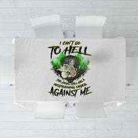 Printed tablecloth showing green skull and devil-themed text graphic in dark ink