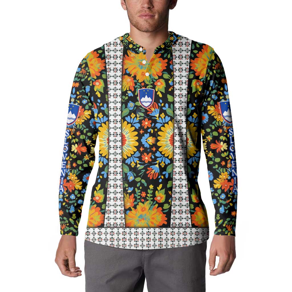 Men's folk floral button sweatshirt with blue shield crest, vertical white trim, long sleeves.