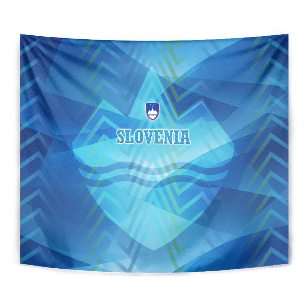 Blue Slovenia tapestry close-up with crest and SLOVENIA text over abstract alpine pattern.