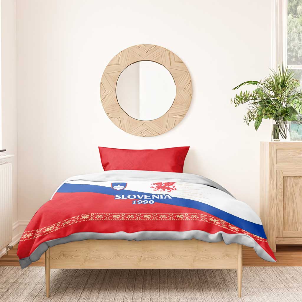 Bed made with red, white and blue duvet cover showing Slovenia 1990 dragon emblem