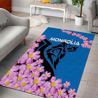 Blue area rug with pink flower border, black wolf graphic, and MONGOLIA text.