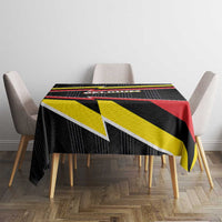 Belgium tablecloth covering dining table with black, red, and yellow lightning stripe trim