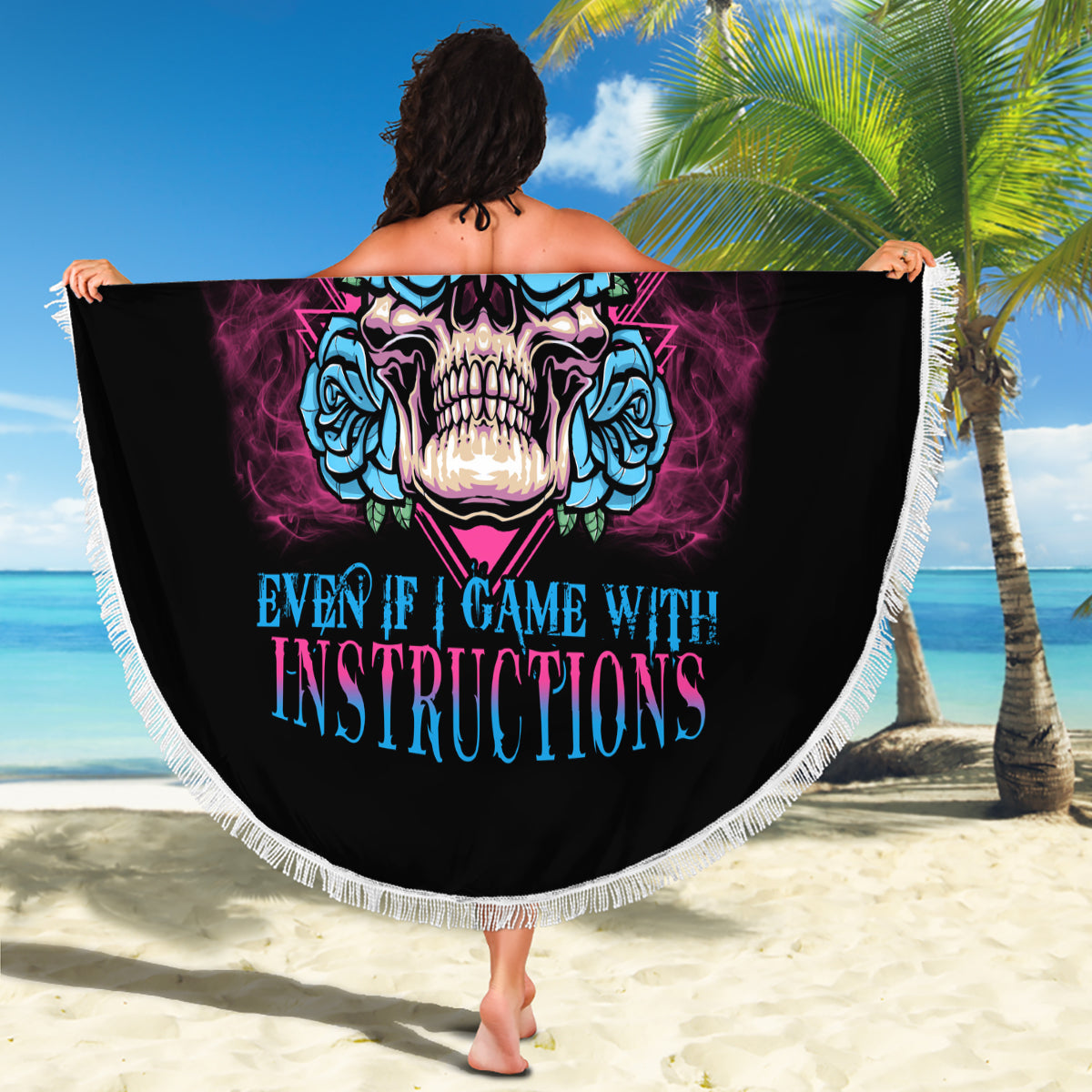 Beach blanket held open with skull and rose graphic, black background, fringe edge