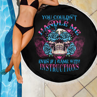 Black beach blanket with blue-and-pink skull and roses graphic, fringe edge