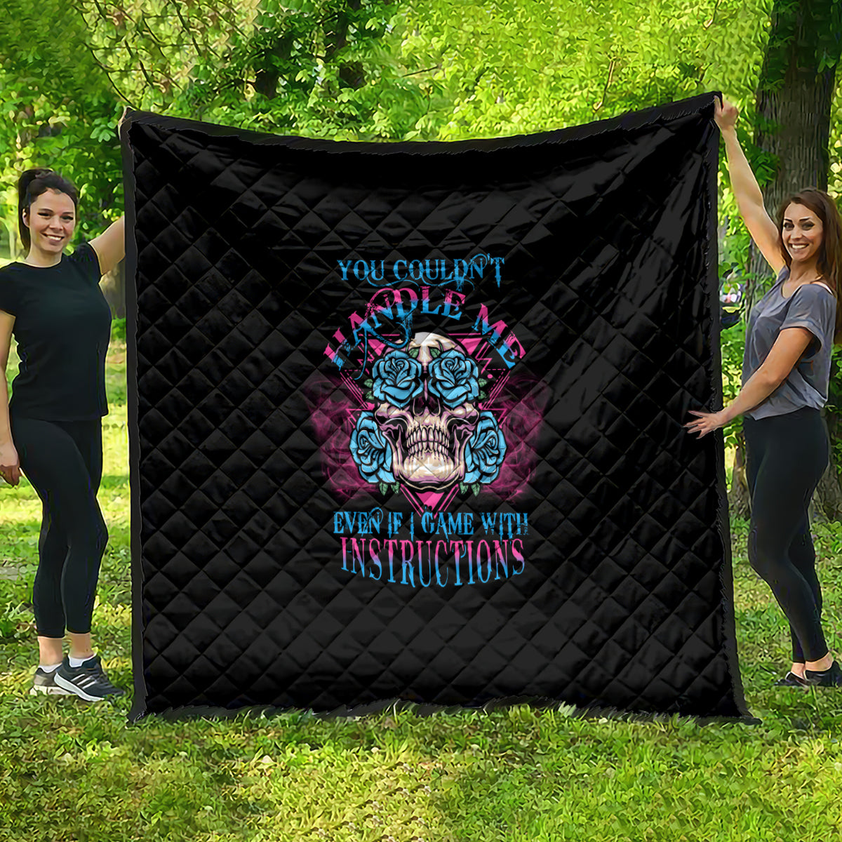 Black quilt with diamond quilting and blue/pink triangle skull graphic, full view