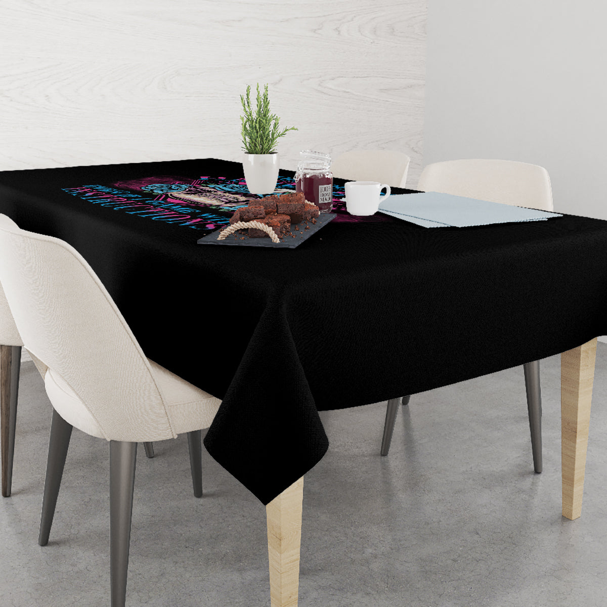 Black triangle tablecloth draped over table with colorful skull print
